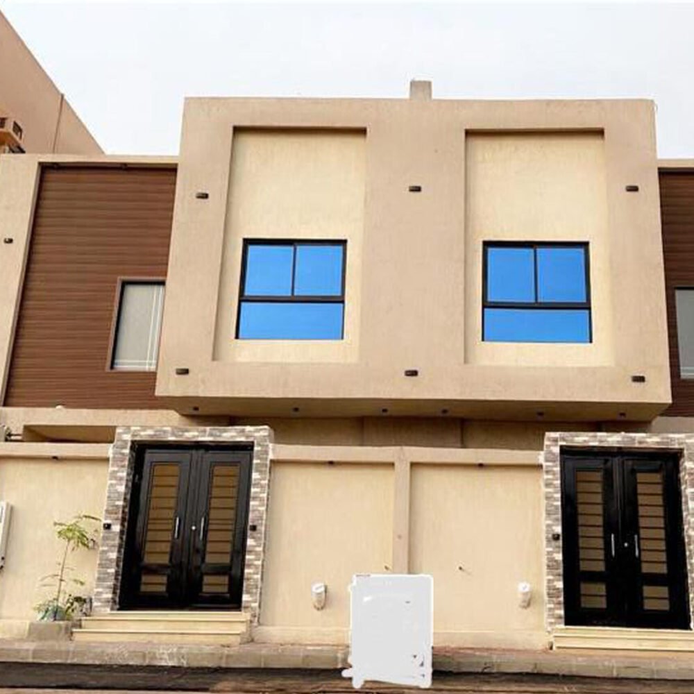A low angle shot of a modern building with glass windows