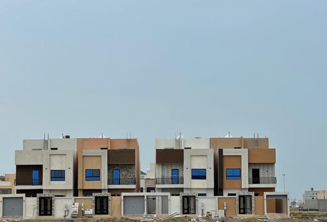 A low angle shot of a modern building with glass windows